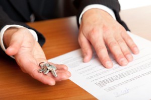 A lawyer holding keys and a document. 